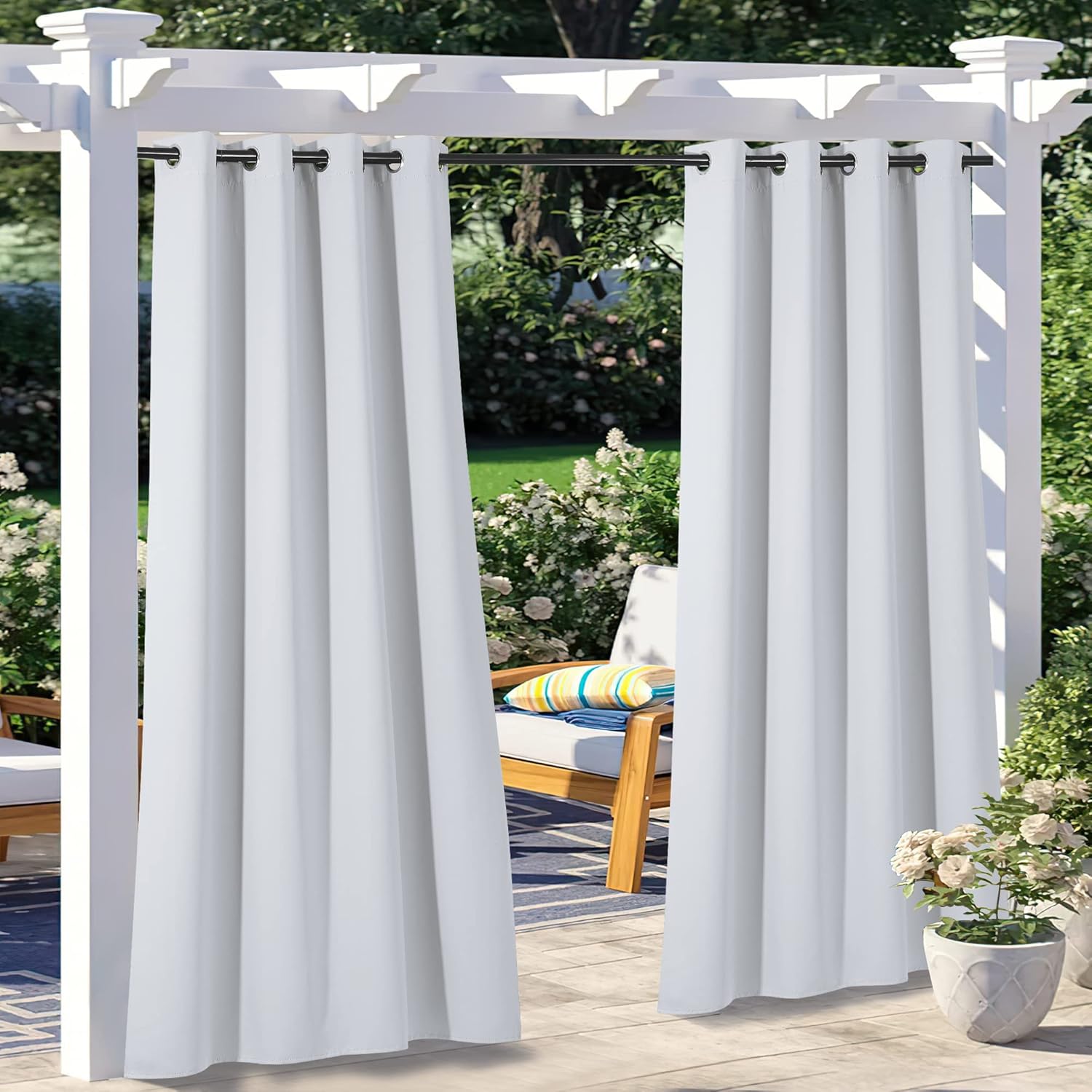 White waterproof outdoor curtains hanging from a pergola, providing privacy on a patio with a chair and potted plants.