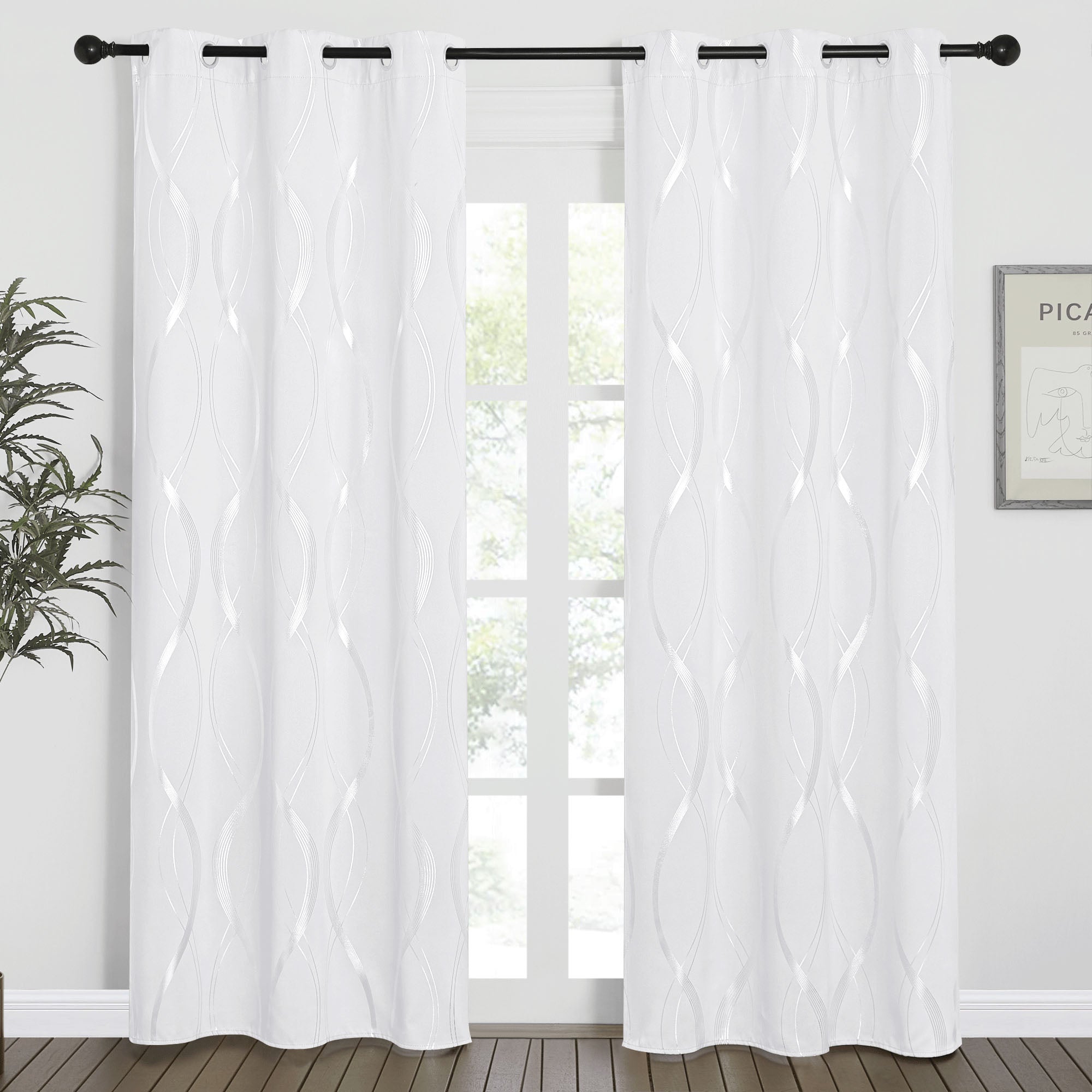 White Wave Line blackout curtains with silver wavy patterns and grommet tops, displayed on a window in a modern living space.