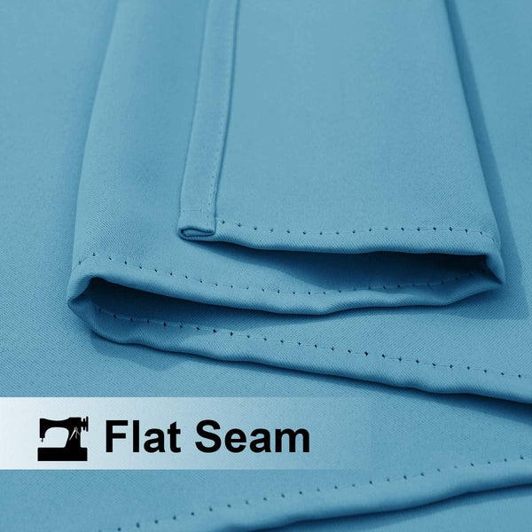Close-up of smooth aqua blue fabric showing a neatly stitched flat seam detail.