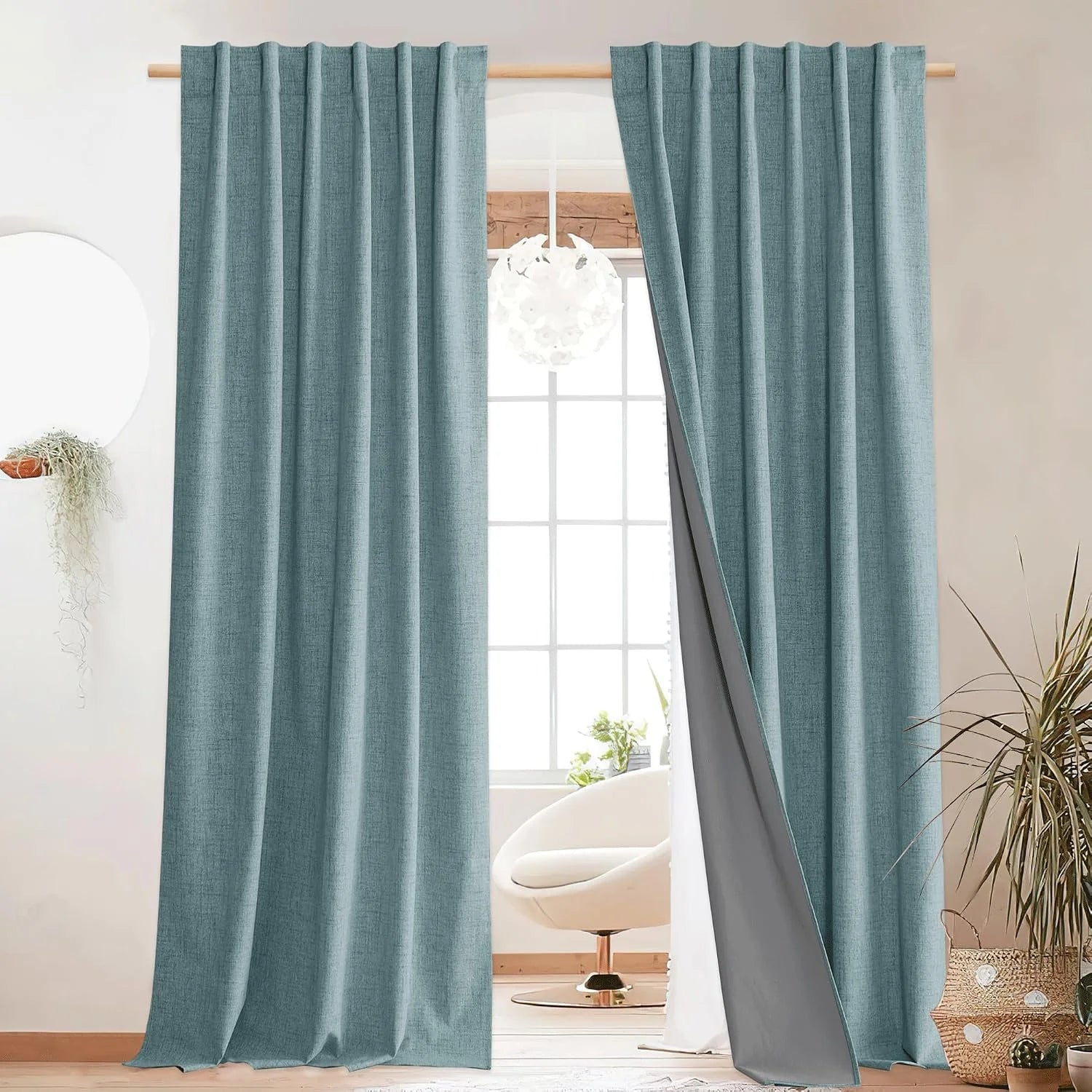 Aqua linen-look blackout curtains on a wooden rod in a bright modern room