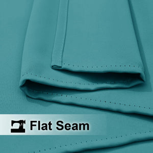 Close-up of aqua teal fabric with a neatly stitched flat seam detail for curtains or drapes.