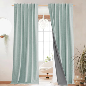 Textured aqua thermal blackout curtains with visible grey backing, hanging on a wooden rod.