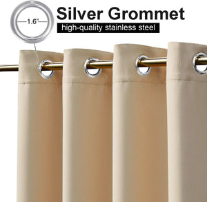 Close-up of beige blackout curtain panels with silver 1.6-inch stainless steel grommets on a gold rod.