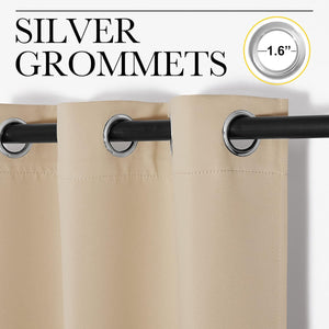Close-up of beige blackout curtain panels with 1.6-inch silver grommets hanging on a black rod.