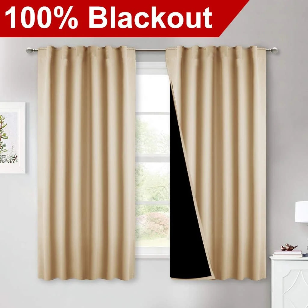 Beige 100% blackout curtains on a rod with black lining in a bright bedroom window