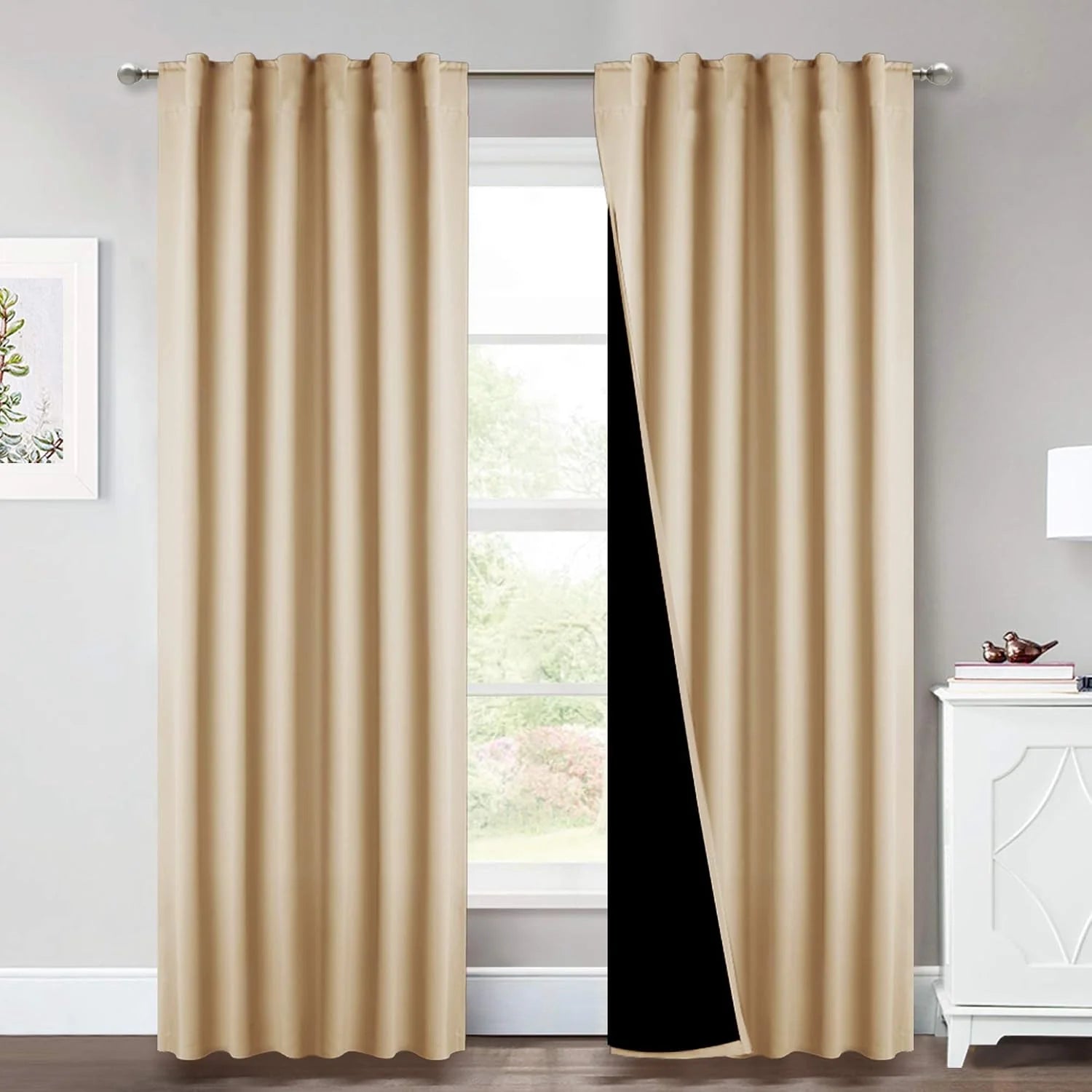 Beige rod pocket blackout curtain panels hanging in a bright modern room