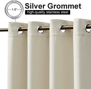 Close-up of beige blackout curtains with silver 1.6 inch stainless steel grommets on a gold curtain rod.