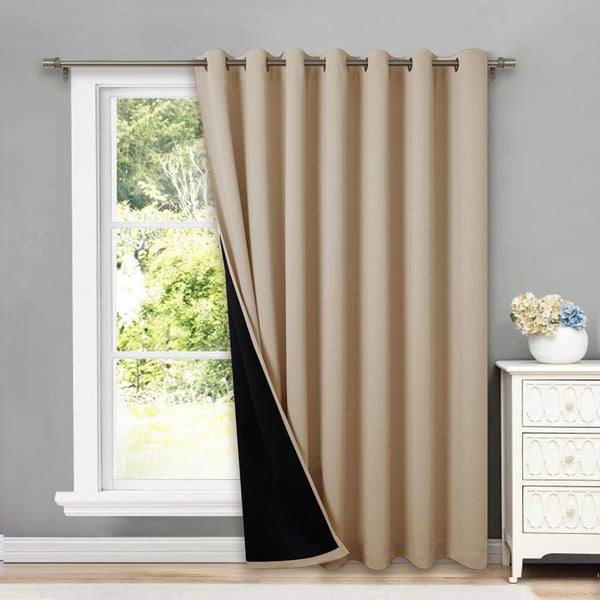Beige blackout grommet top curtain panel partially open, hanging on a silver rod, showing its black thermal lining.