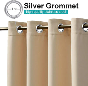 Beige blackout curtains with shiny silver 1.6-inch stainless steel grommets on a curtain rod.