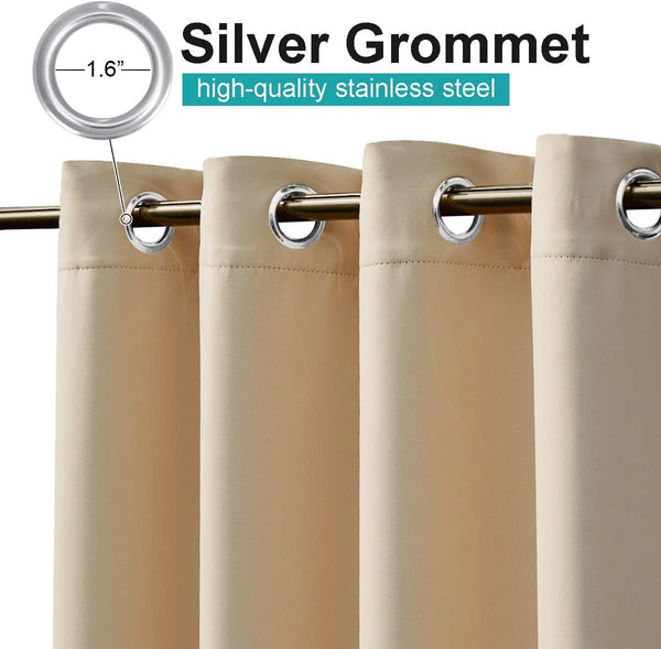 Beige blackout curtains with shiny silver 1.6-inch stainless steel grommets on a curtain rod.
