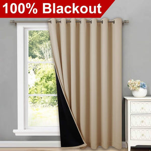 Beige blackout curtain with grommet top on window. Visible black lining confirms light-blocking.