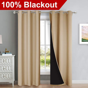 Beige blackout curtains with silver grommet top hanging. One panel reveals black thermal lining inside.