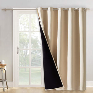 Beige thermal blackout grommet curtain with black lining covering a white patio door.