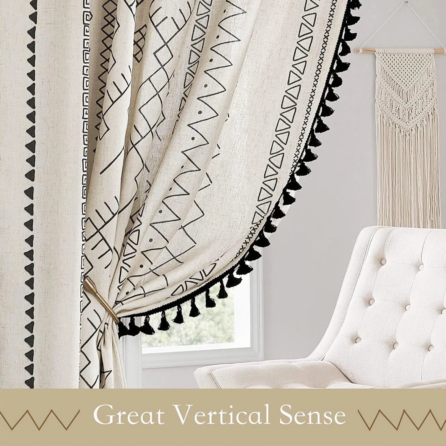 Beige boho curtain with black geometric print and tassel trim beside an armchair