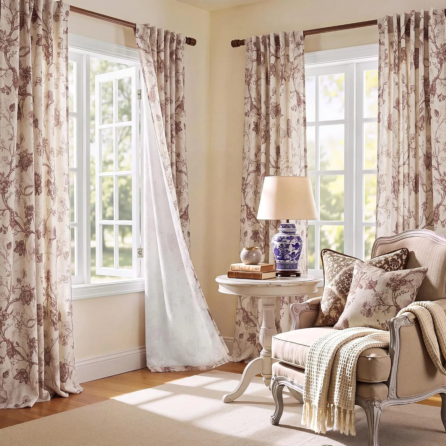 Beige botanical print curtains on white windows in a cozy traditional sitting room