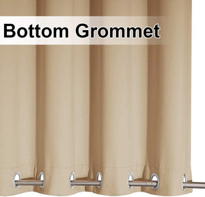 Close-up of a beige curtain panel featuring silver bottom grommets on a metal rod.