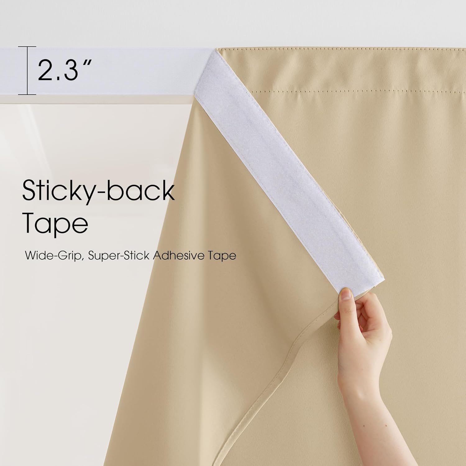 Hand revealing a 2.3-inch wide white sticky-back adhesive tape attached to a beige fabric curtain.