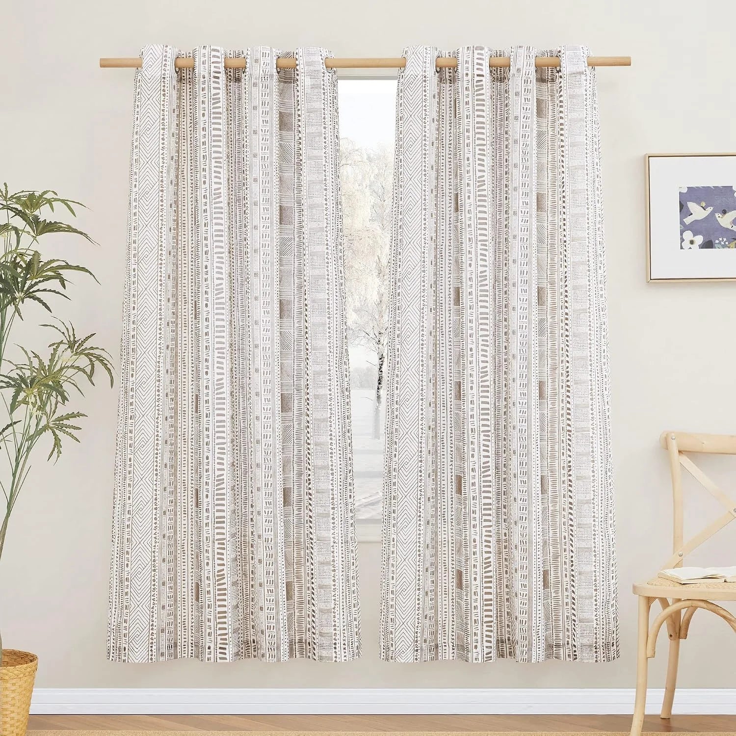Beige geometric patterned curtains on a wooden rod in a bright minimalist room