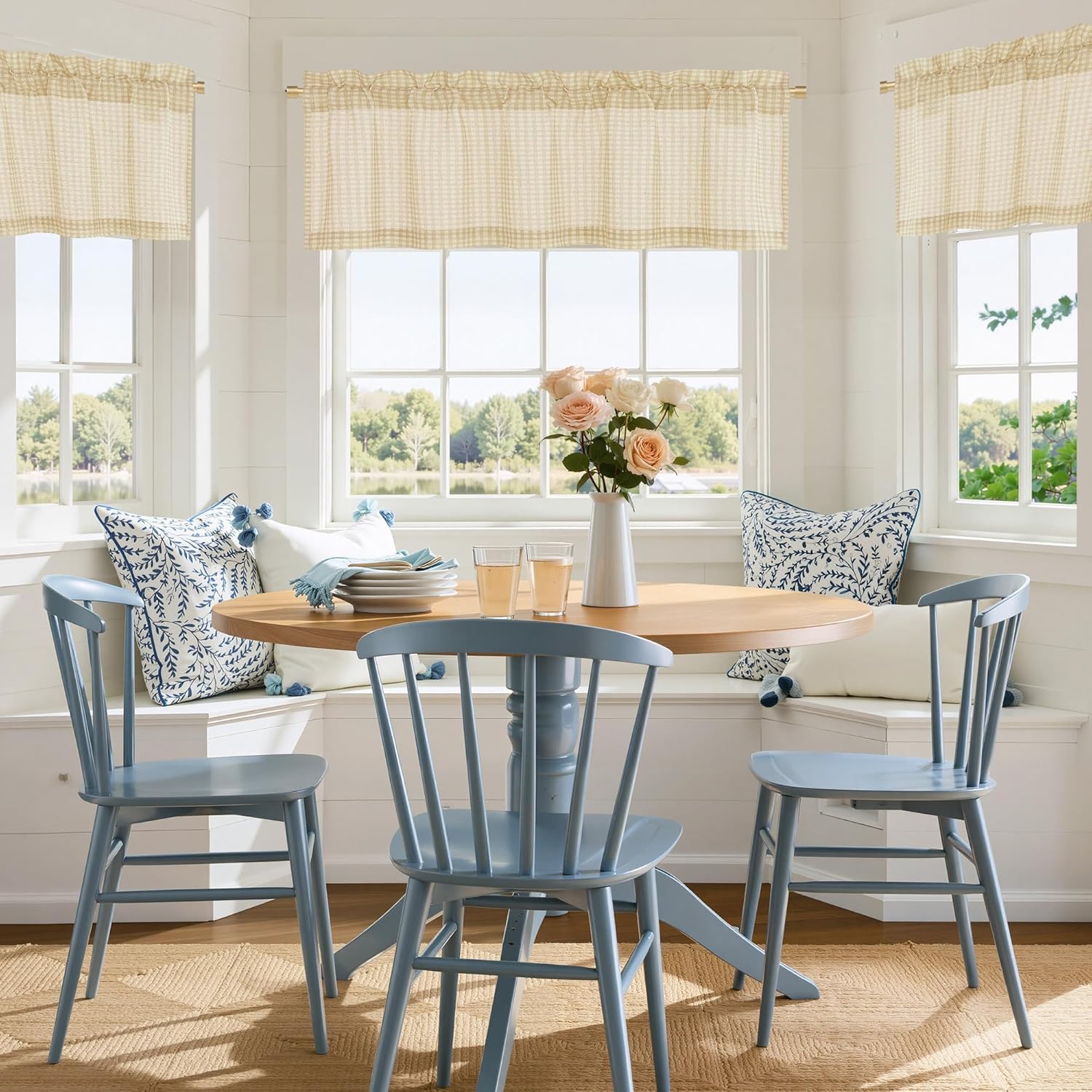 Light beige gingham pattern rod pocket valances with ruffled top in bright kitchen window nook.