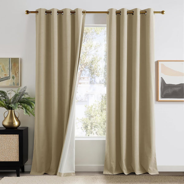 Light beige grommet top curtains with white backing, hanging on a brass rod. One panel is slightly open.