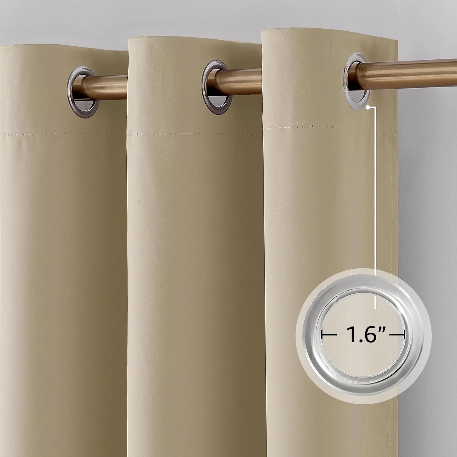 Close-up of beige grommet top curtain panel on a gold rod, showing 1.6 inch grommet size.