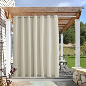 Beige outdoor curtain with silver grommets hangs from a rod under a wooden pergola, providing patio privacy.
