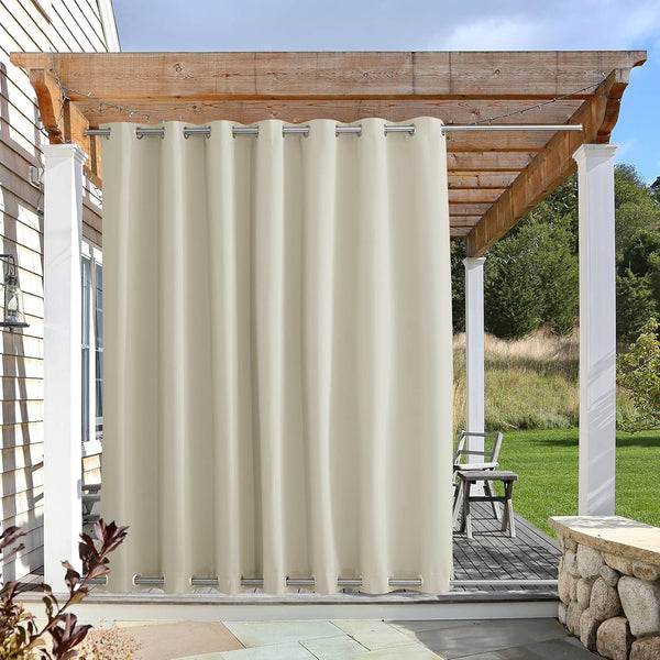 Beige outdoor curtain with silver grommets hangs from a rod under a wooden pergola, providing patio privacy.