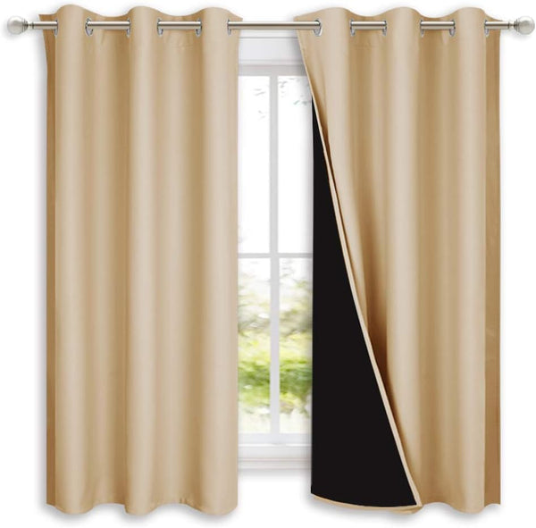 Pair of beige thermal blackout curtains with silver grommet tops. One panel shows black thermal lining.