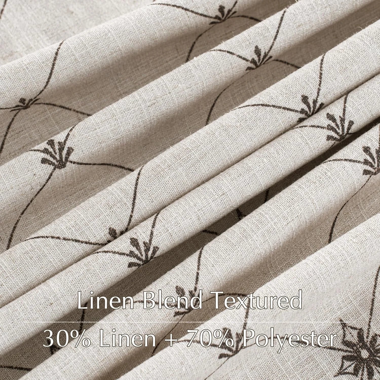Beige linen blend textured fabric with brown floral vine pattern in close-up folds