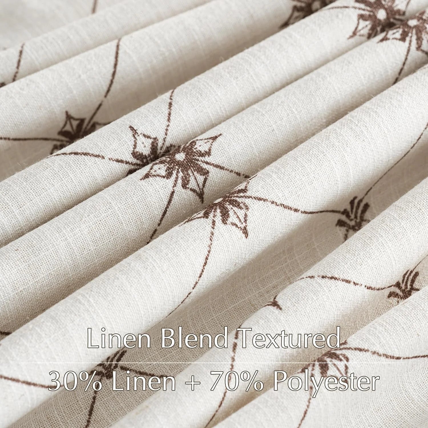 Close-up of beige linen blend fabric with brown floral print and textured folds