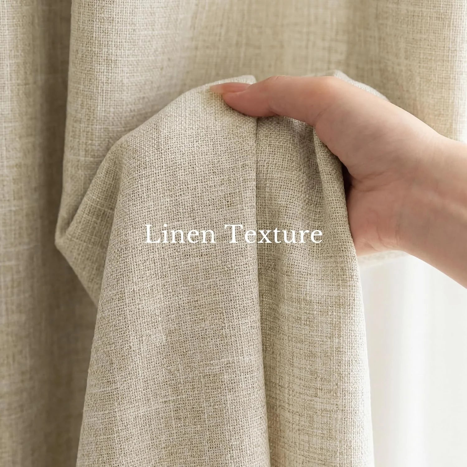 Close-up of a hand holding natural beige linen fabric, revealing its textured weave.