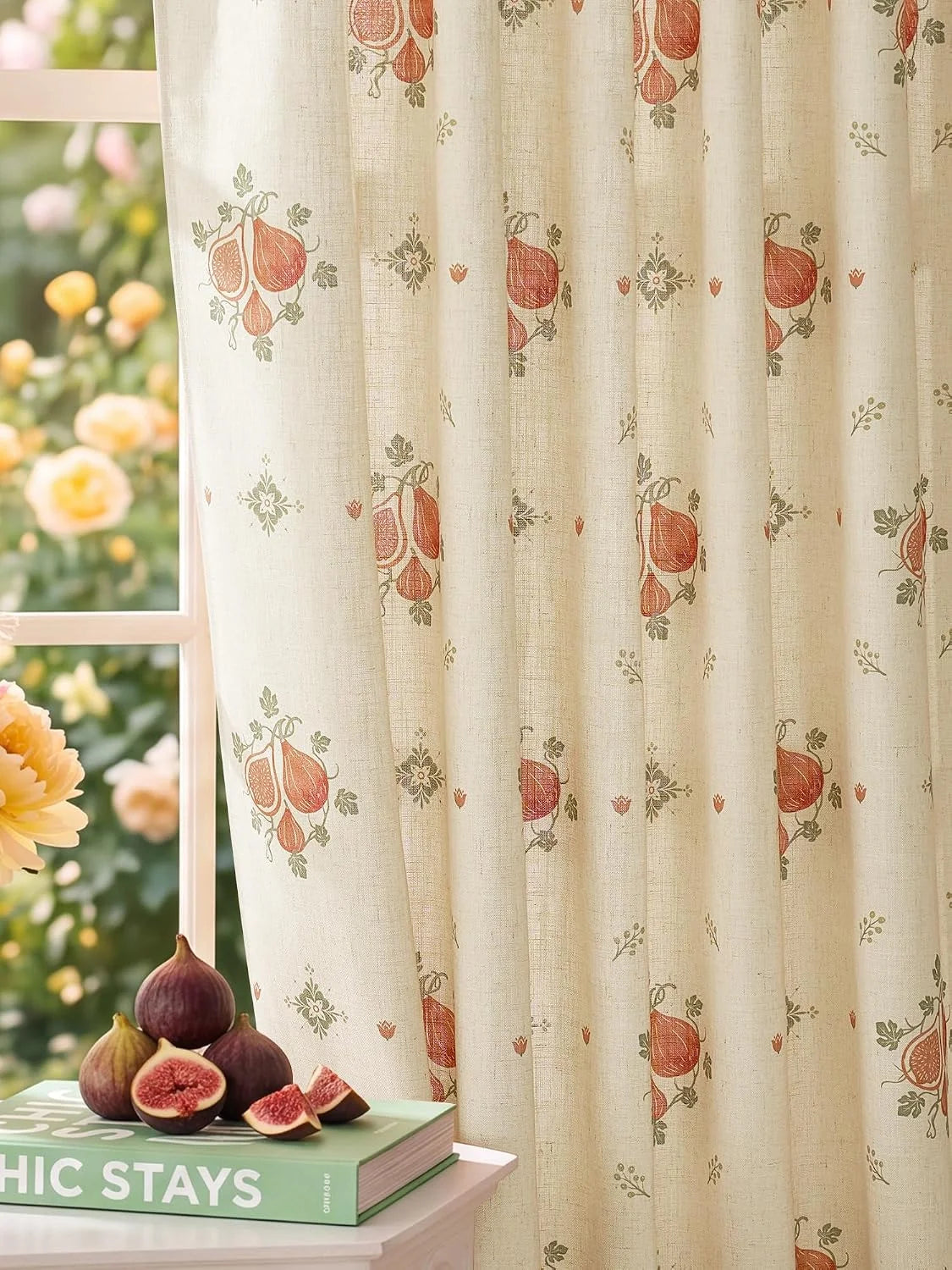 Beige linen-look curtain with terracotta fig print beside a sunlit window