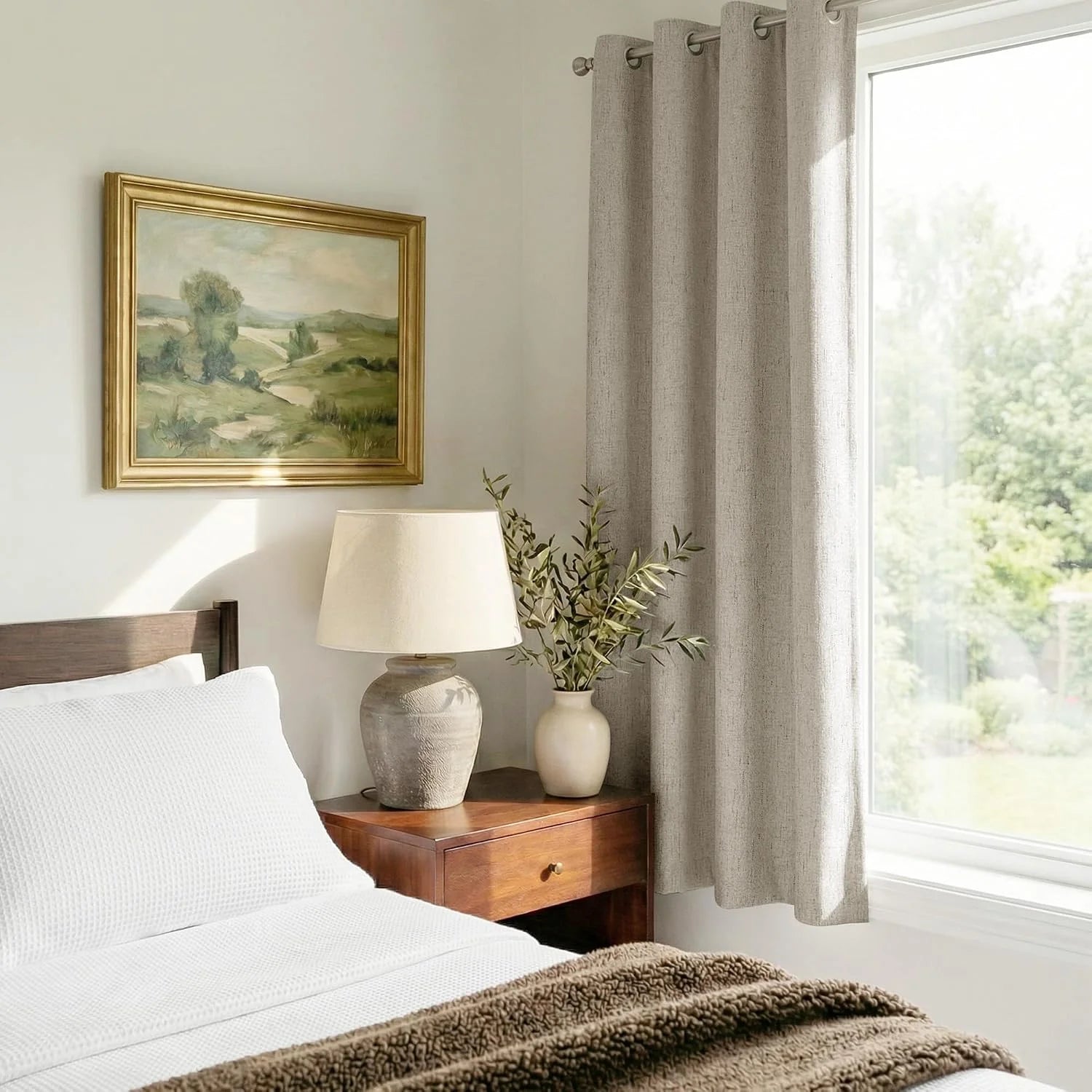 Beige textured grommet curtain beside a bright bedroom window with wood nightstand