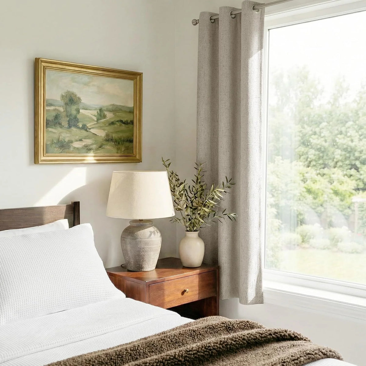 Beige linen-look grommet curtain beside a bright bedroom window with warm wood decor