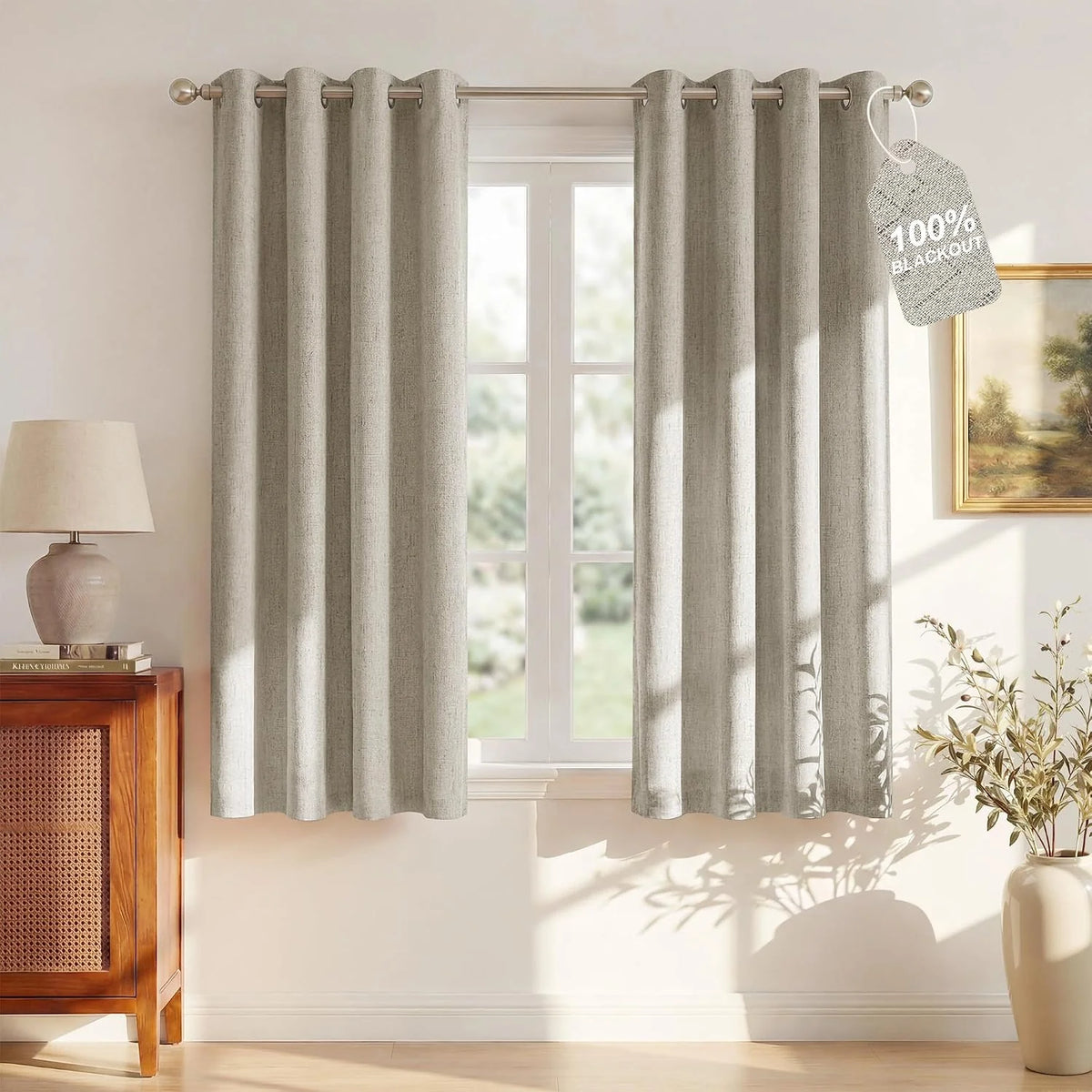 Beige linen-look blackout curtains with grommet top on a sunlit window