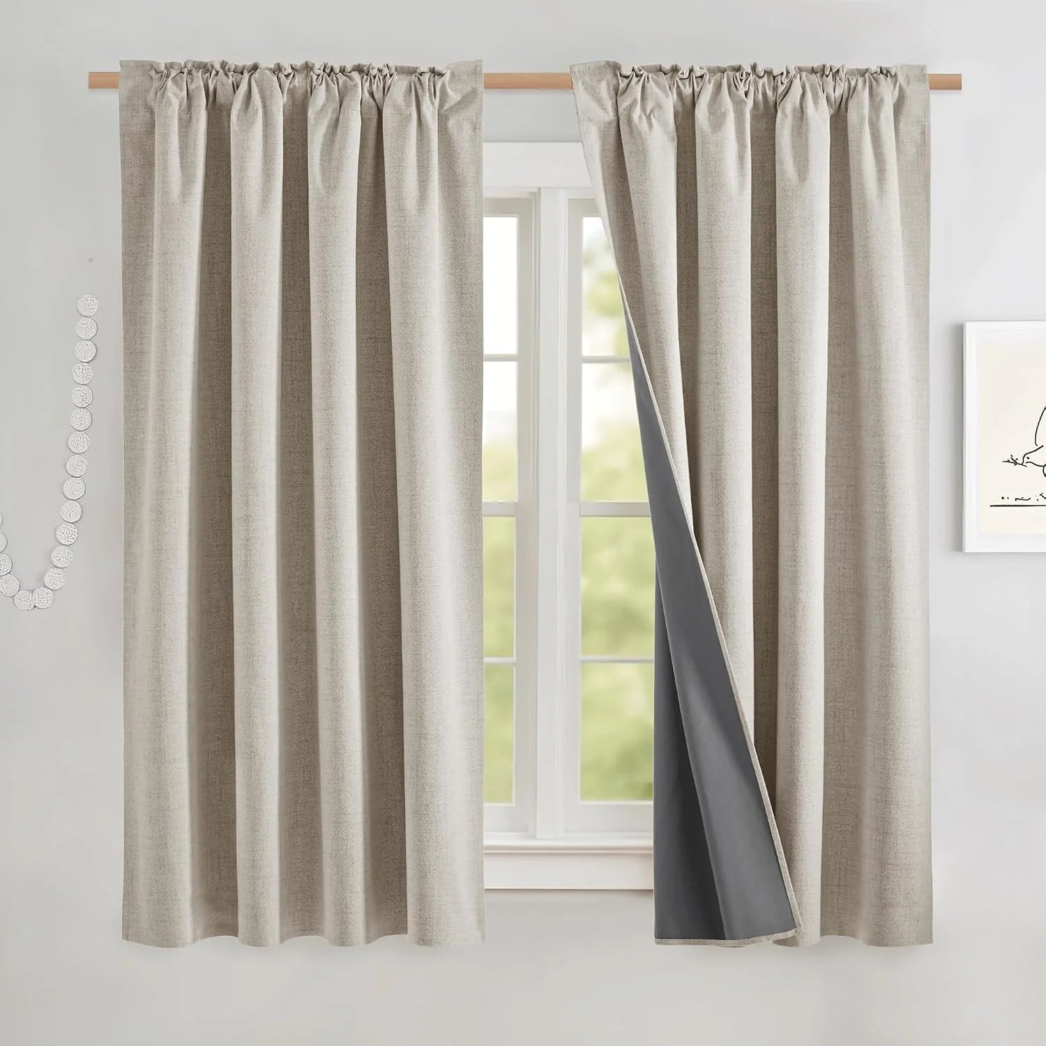 Beige linen-look blackout curtains with gathered header on a wooden rod