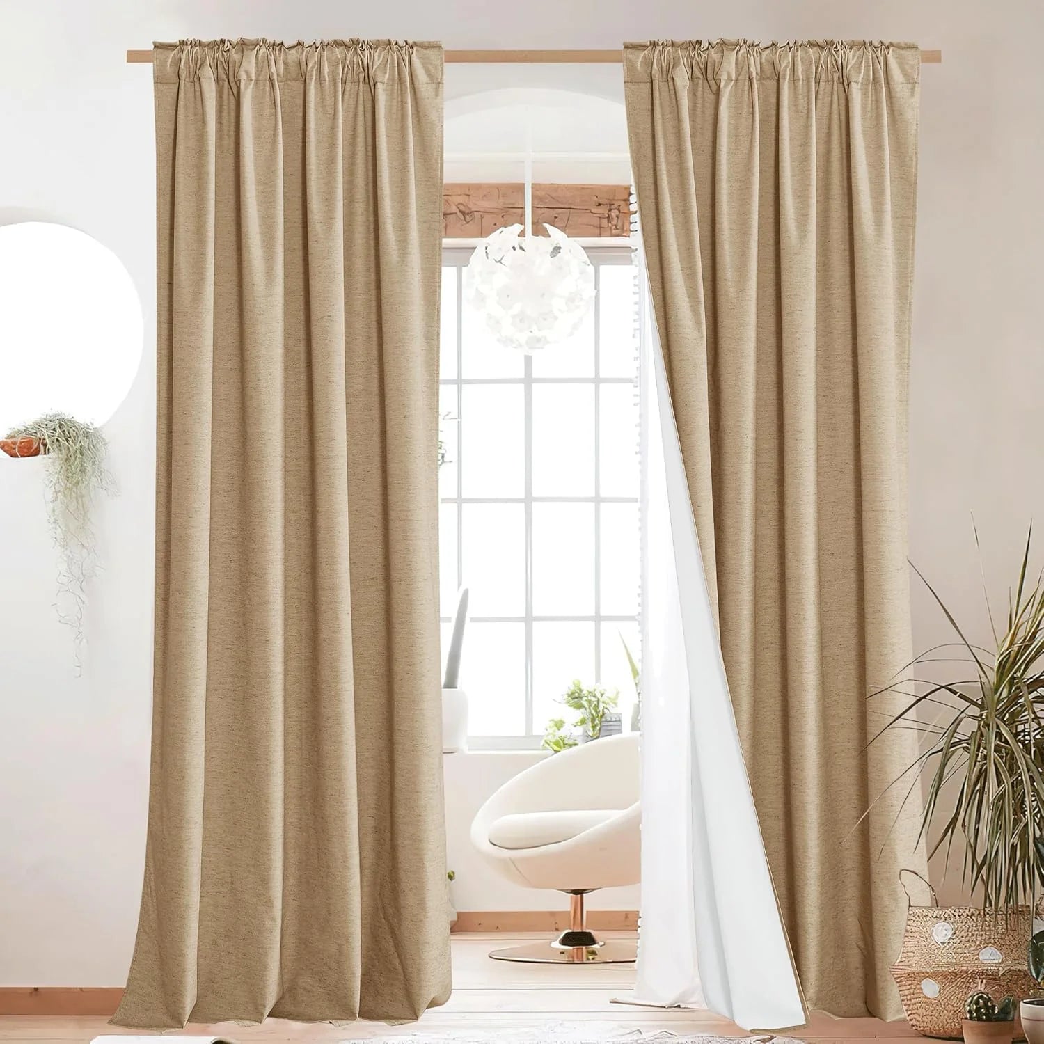 Beige linen-look rod pocket curtains framing a bright window in a modern room