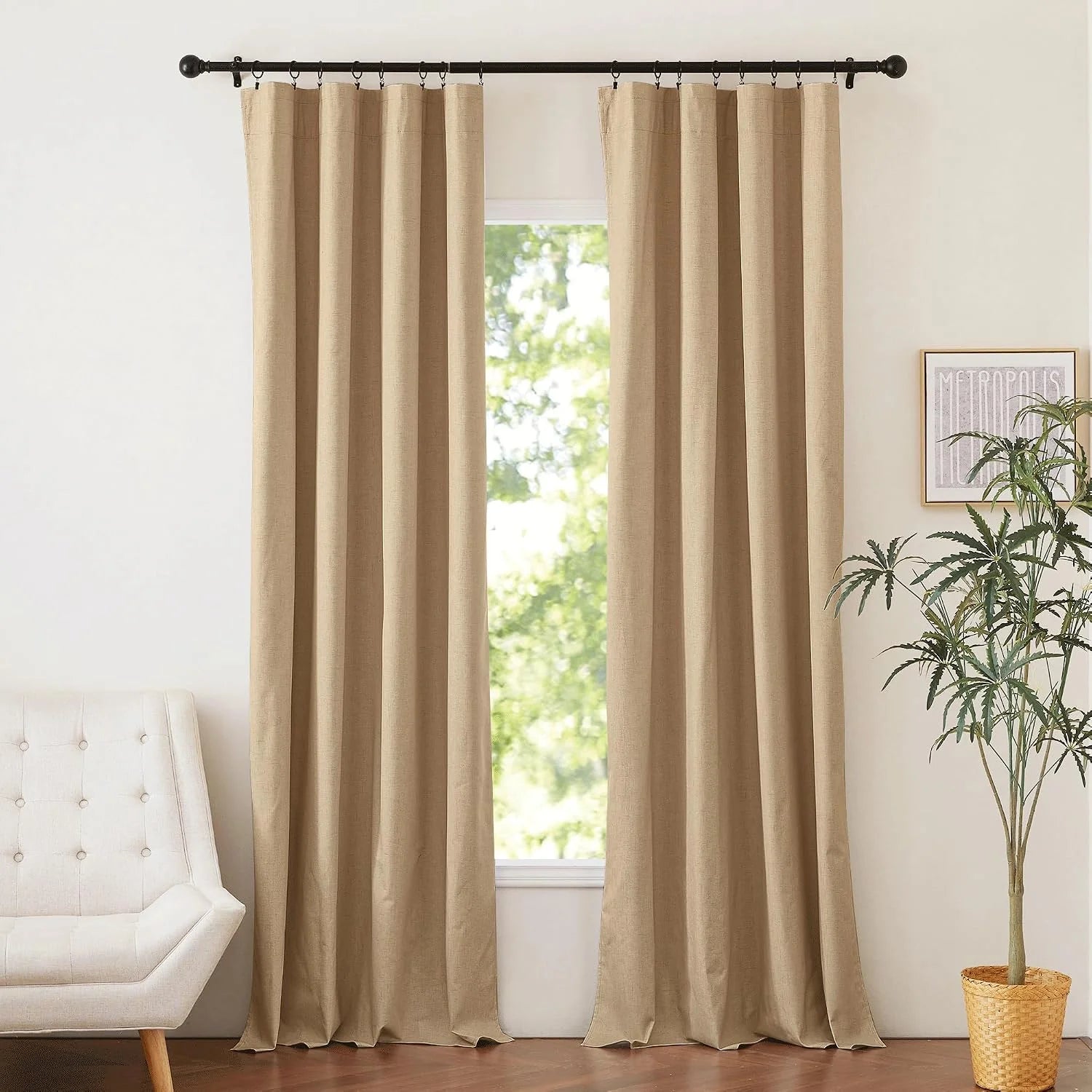 Beige linen-look curtains on black rod in a bright modern living room window