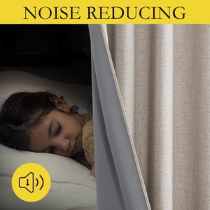 Beige textured noise reducing curtain with gray backing creating a dark, quiet room for sleep.