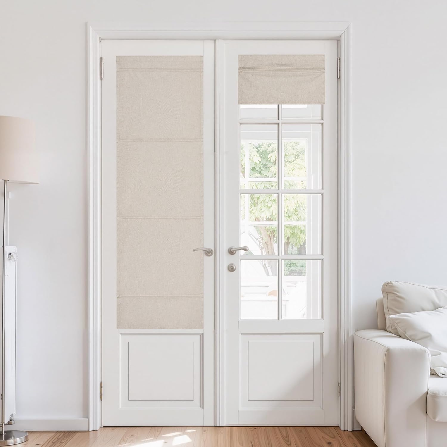 Beige linen flat fold roman shades on white French doors. One extended, other partially raised.