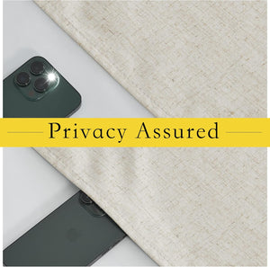 Beige textured linen-look privacy curtain fabric blocking a smartphone camera flash, demonstrating light and privacy protection.