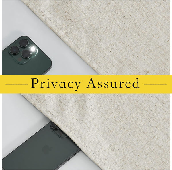 Beige textured linen-look privacy curtain fabric blocking a smartphone camera flash, demonstrating light and privacy protection.