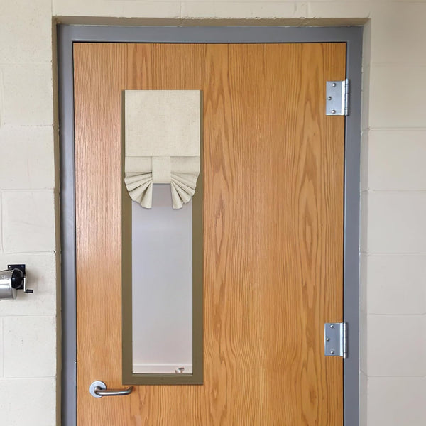 Natural linen tie-up privacy shade with decorative pleated bottom on a door window.