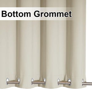 Light beige opaque curtain with silver bottom grommets and a metal rod threaded through.