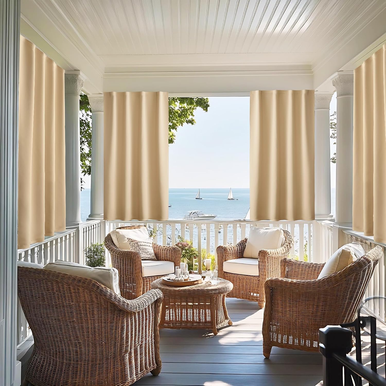 Beige outdoor patio privacy curtains on a covered porch with wicker furniture and lake view.