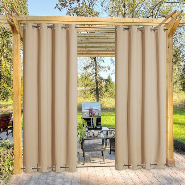 Beige outdoor curtains with grommet tops and bottoms hanging on a wooden pergola, creating a private patio space.