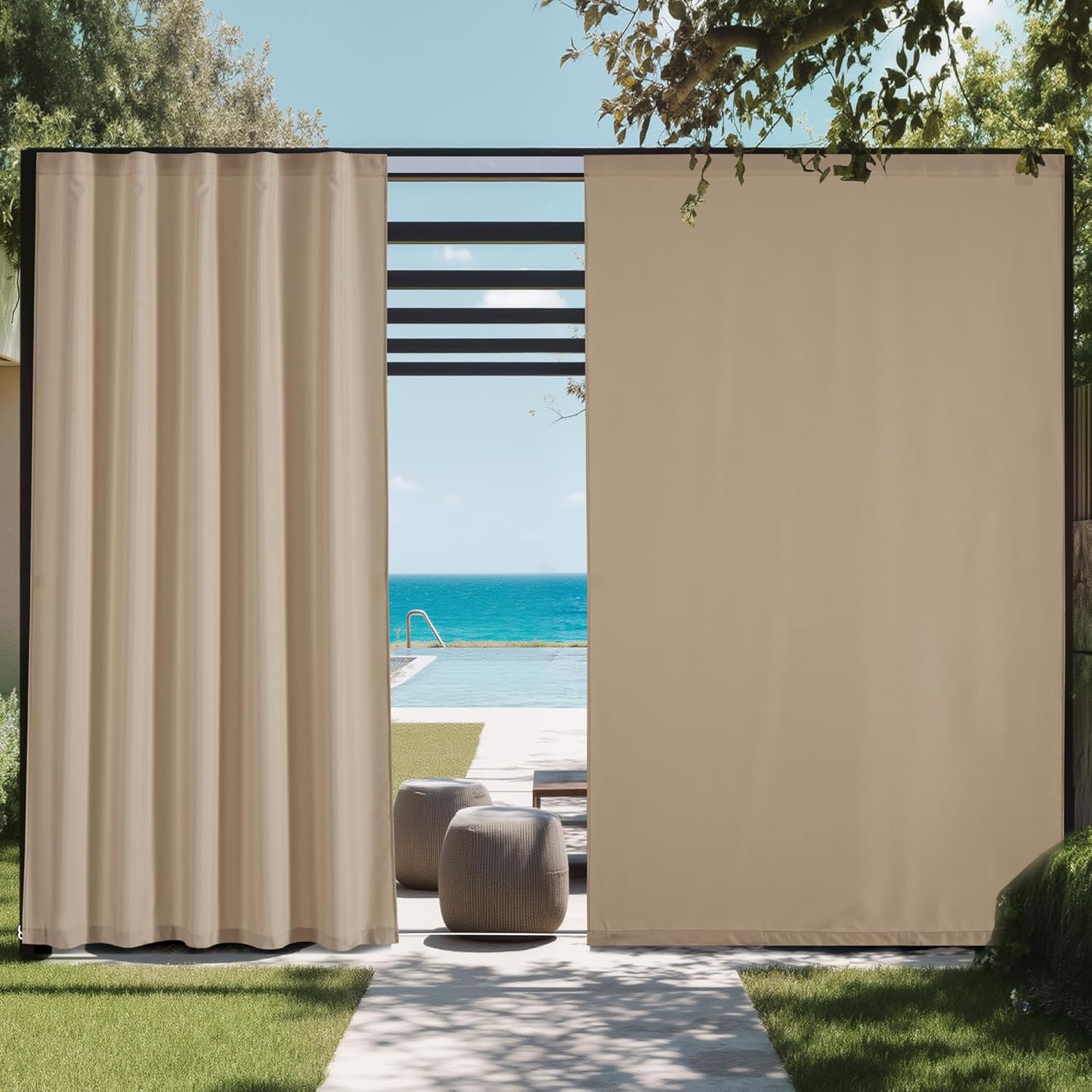 Beige outdoor patio privacy curtains, one draped open, with an ocean and pool view.