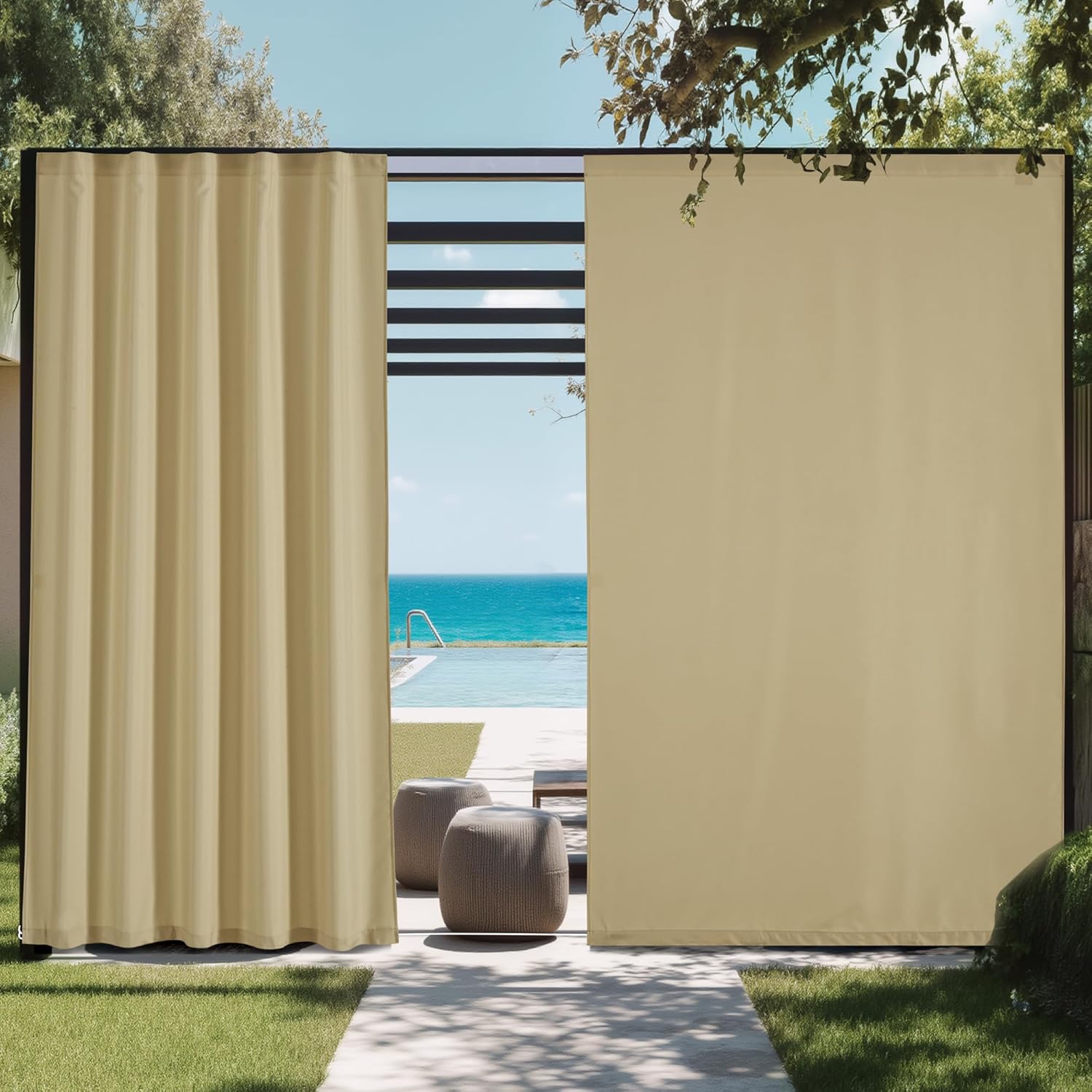 Beige outdoor patio privacy curtains hanging from black frame, next to pool and ocean.