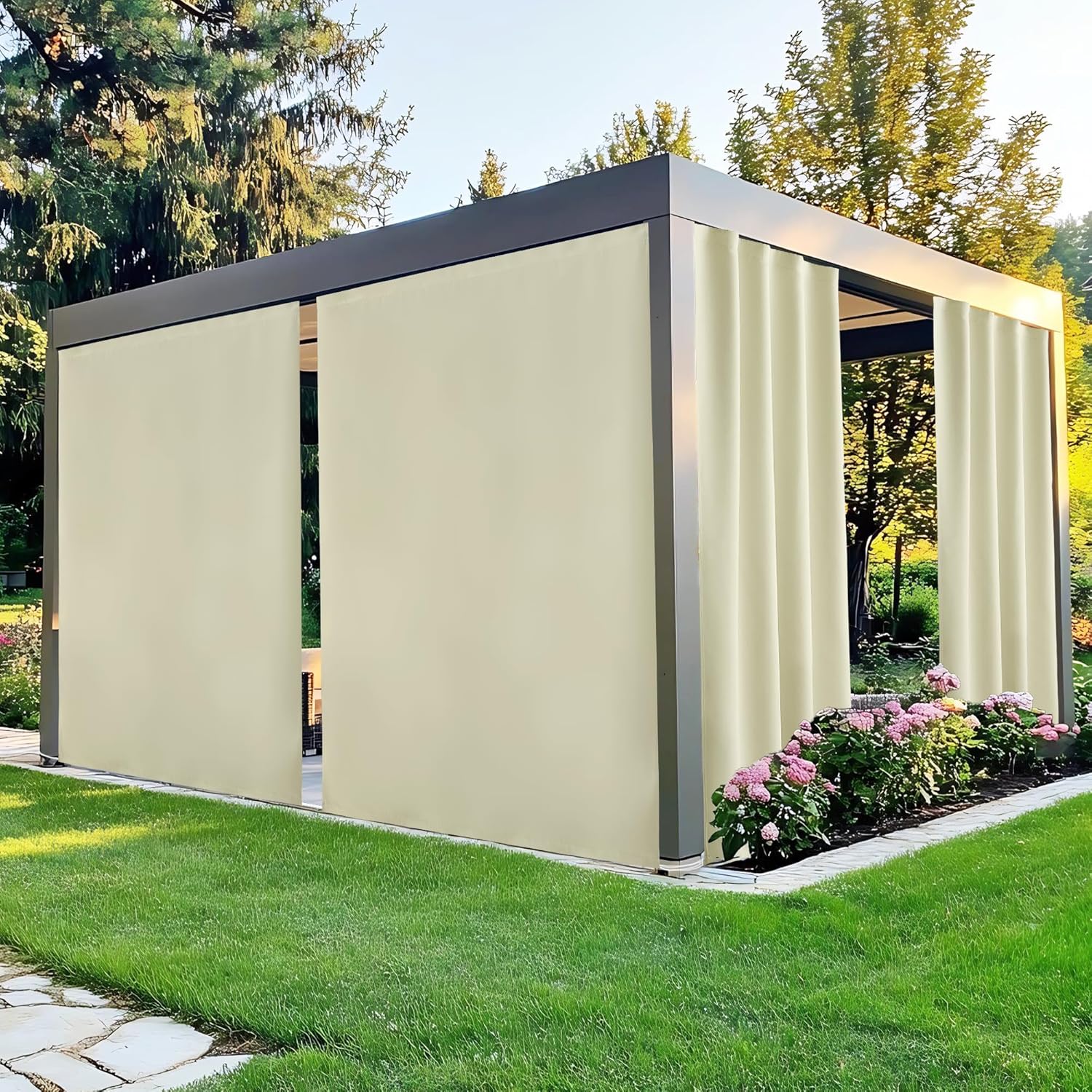 Modern dark grey outdoor pergola with beige retractable privacy curtains on a green lawn.