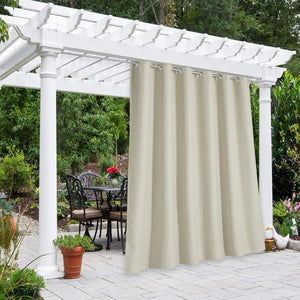 Beige outdoor grommet curtain on white pergola provides privacy for patio dining area.
